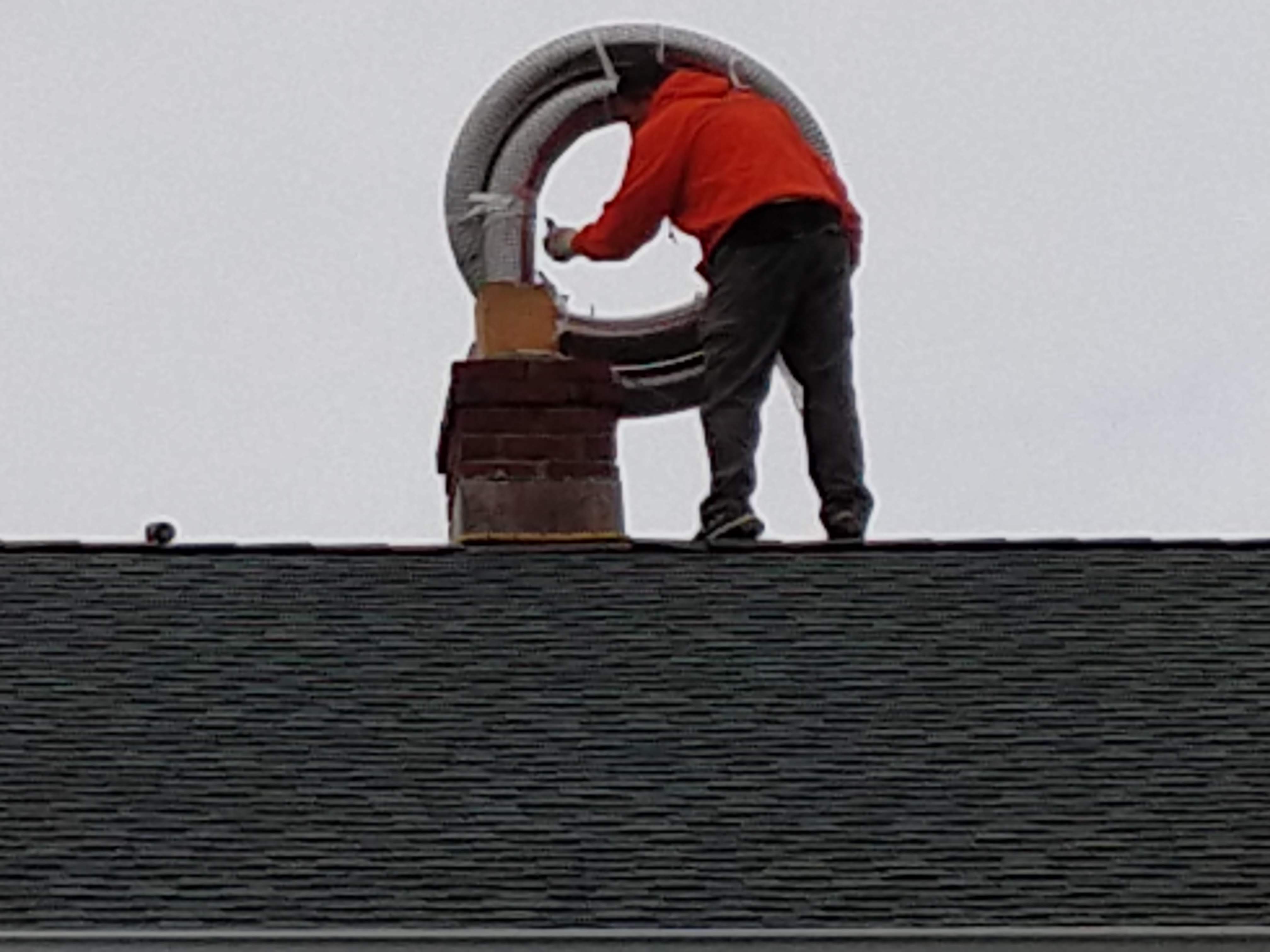 Flexible stainless chimney liner being installed in Massapequa, New York